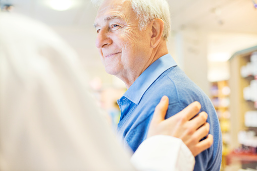 Older man smiling at his periodontist